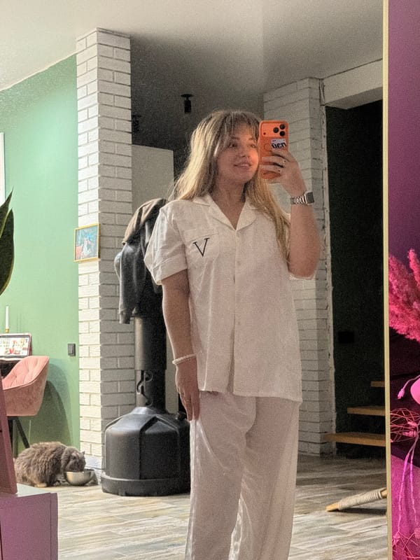 Woman takes mirror selfie in pajamas in Russian village