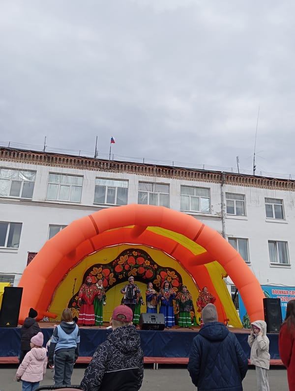 Street gathering documented in Yurgamysh, Russia amid overcast conditions