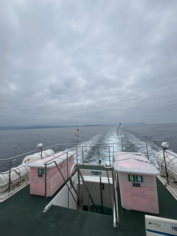 Ferry stern cutting through calm Galician coastal waters