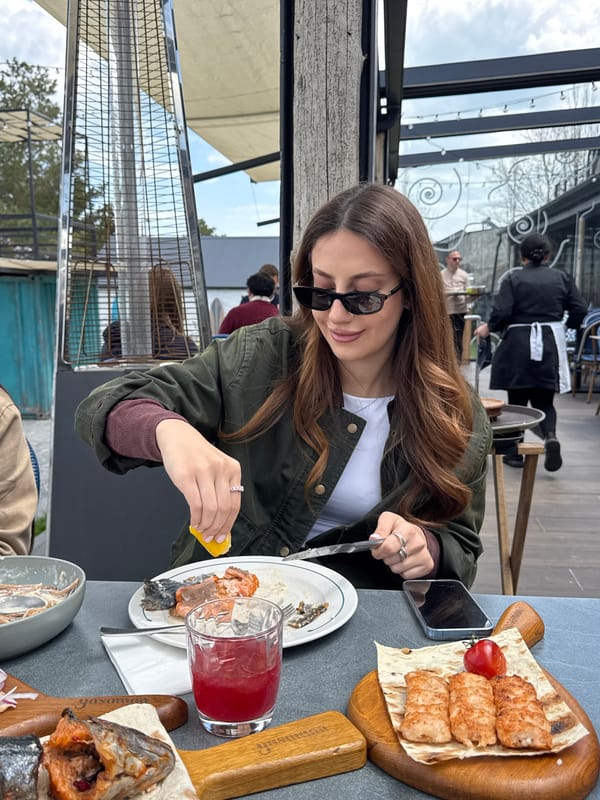 Woman enjoys lakeside meal at Armenian restaurant