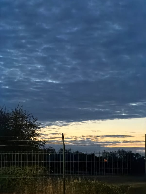 Twilight sky over Luxembourg, barbed wire and open horizon