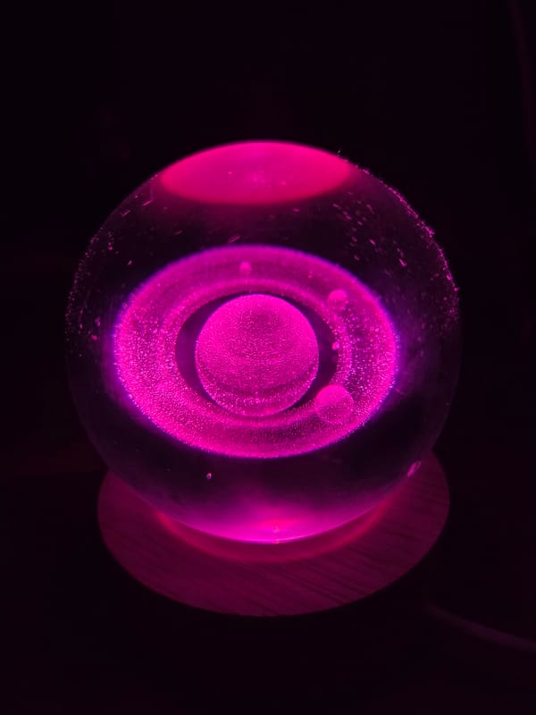 Evening documentation of illuminated Saturn model and pet dog