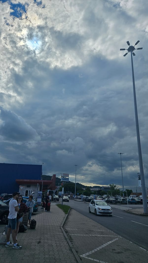 Tour group boards buses at Prešov shopping center