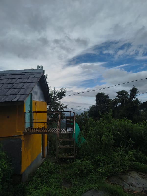 Rainy morning at a Himalayan village, fires lit and fading