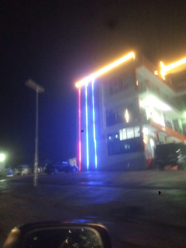 Building displays decorative lighting in Gwarinpa neighborhood at night