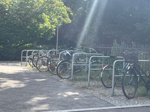 Berlin neighborhood walk featuring street art, bikes, and hanging shoes