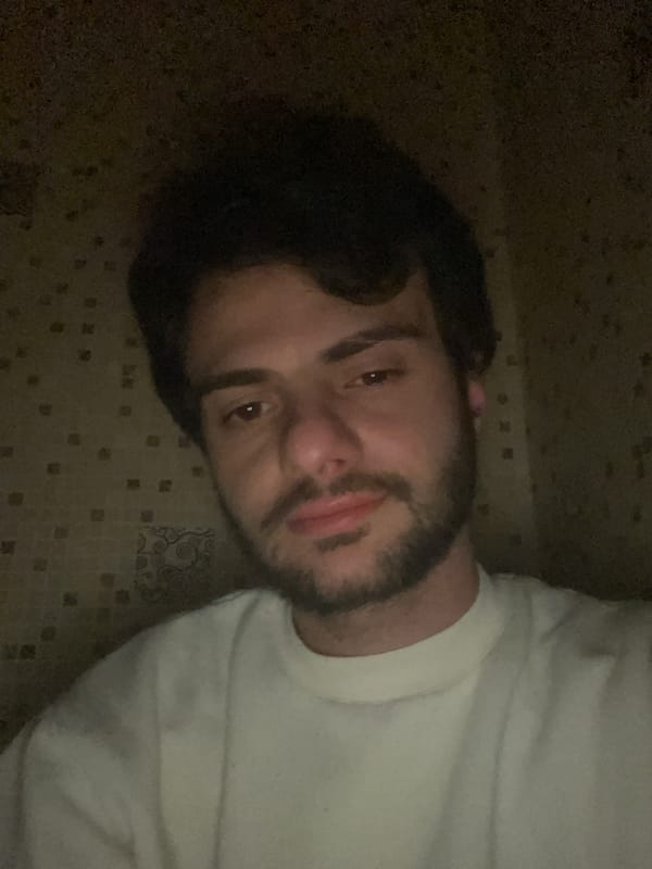 Man takes multiple selfies indoors in Tbilisi