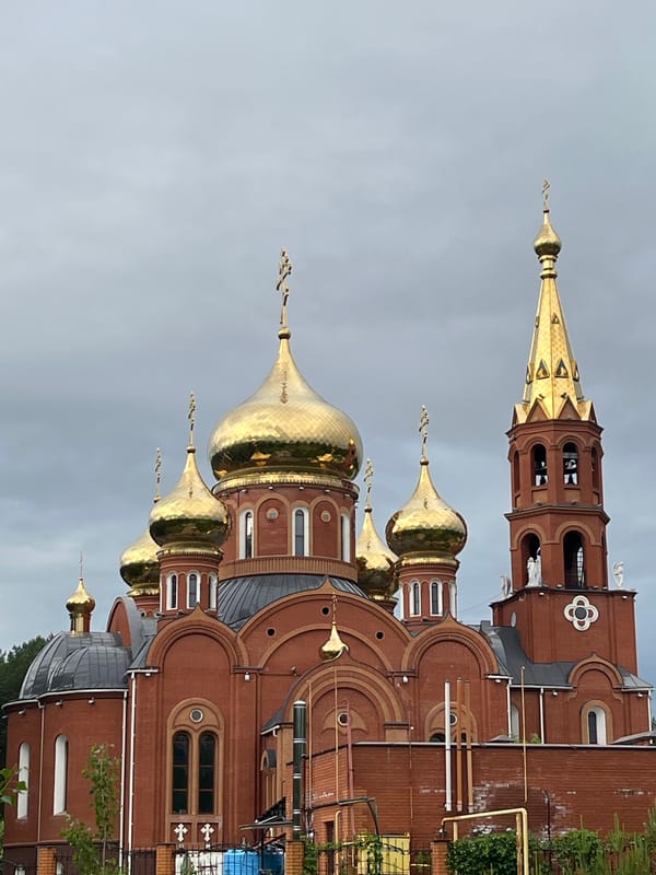 Early morning cyclist spotted near Orthodox church in Chaikovsky