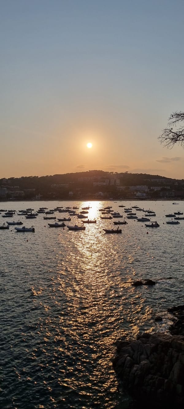 Golden hour over a boat-filled bay in Platja d'Aro