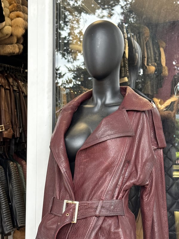 Store window display features burgundy leather garment in Montenegro