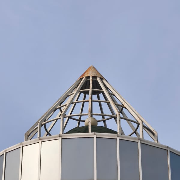 Metal pyramid structure documented atop building in Hrodna
