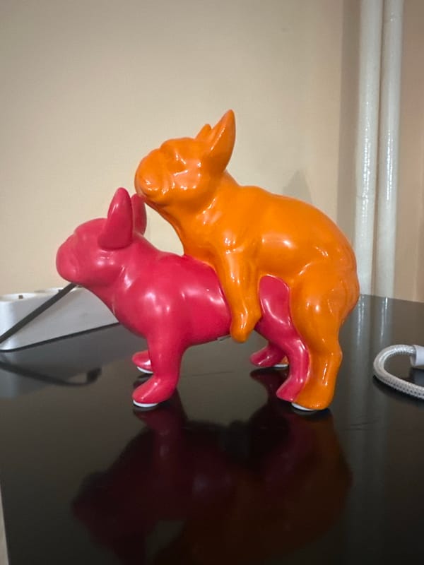 French Bulldog, ceramic pigs, alcohol bottles captured in home setting