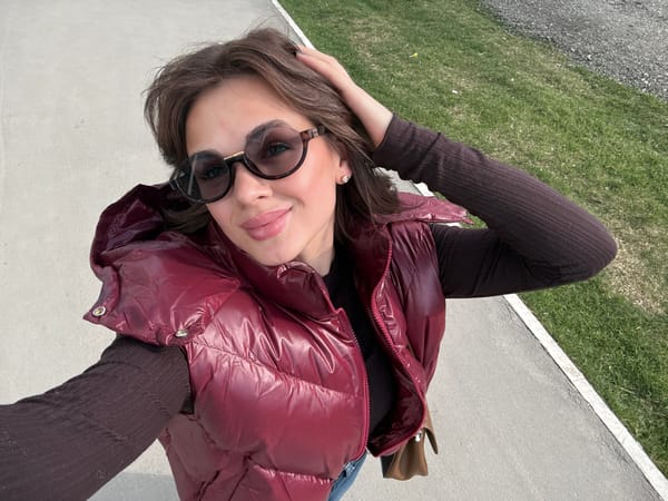 Woman in maroon vest spotted on Perm sidewalk