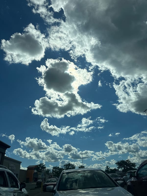 Summer sky over a Rockford parking lot, clouds and sun
