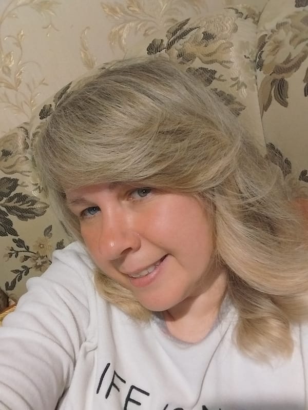 Woman captures relaxed selfies on couch in Orenburg