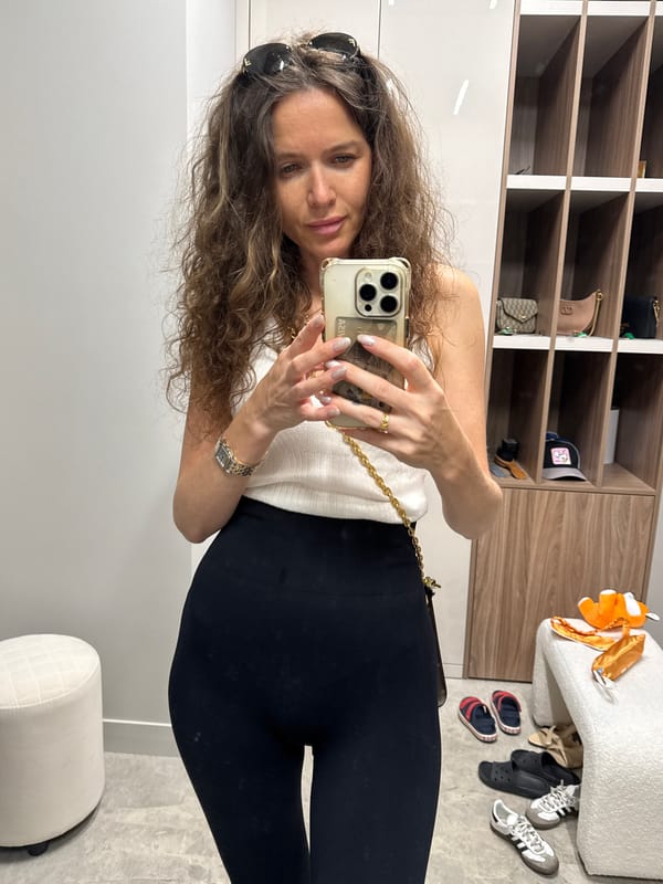 Woman takes mirror selfies in dressing room area