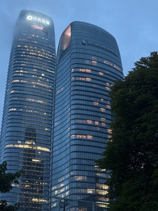 Haizhu District waterfront at dusk, towers lit along the Pearl River
