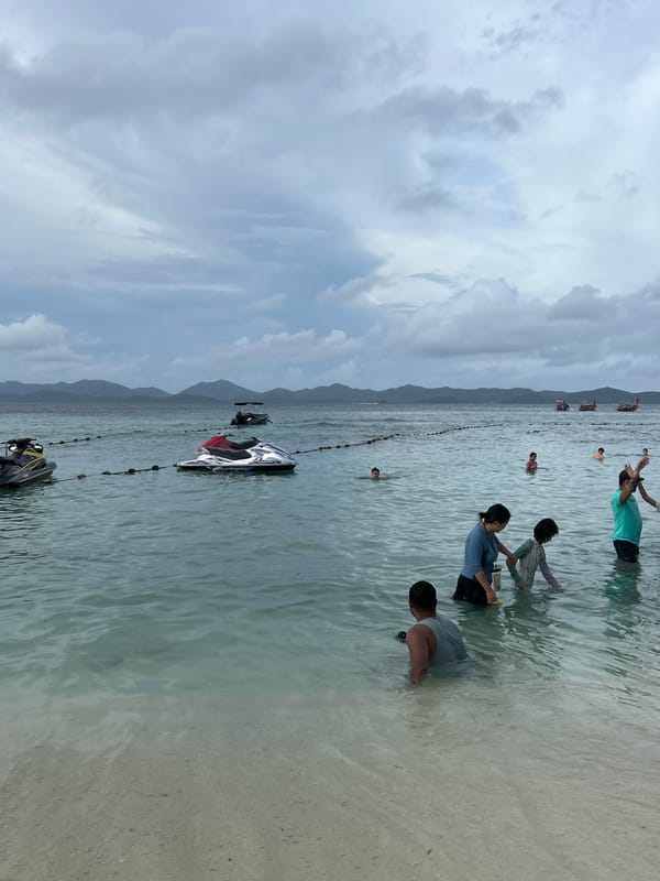 Crowded beach morning in Phru Nai with jet skis and families