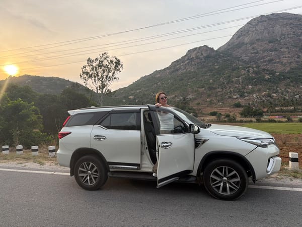 Woman stops beside white SUV on Muddenahalli road