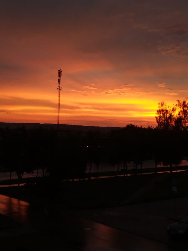 Sunset silhouettes a communication tower over Vawkavysk, Belarus
