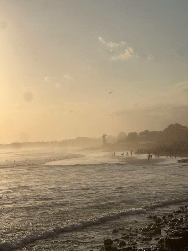 Golden hour at North Kuta Beach — crowds, food stalls, sunset