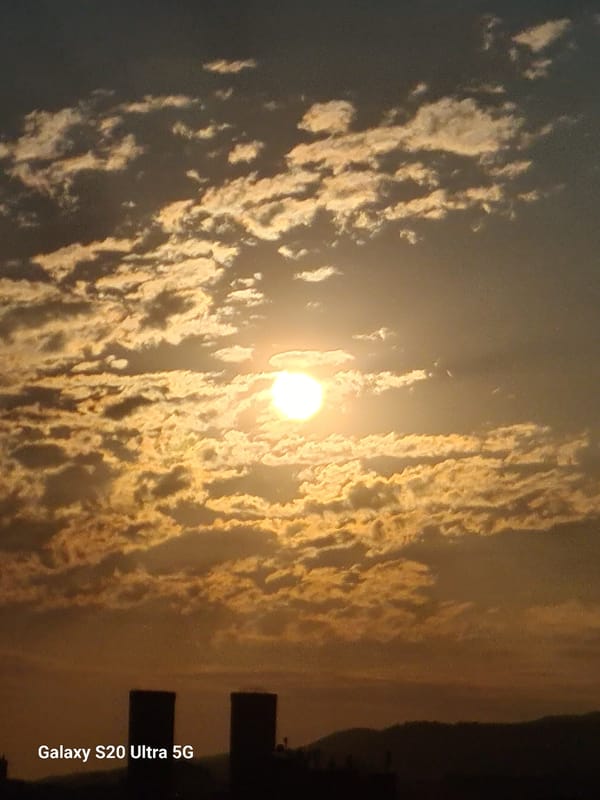 Golden sunset breaks through clouds over Almaty