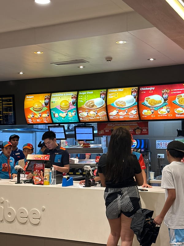 Rainy evening at a Davao City Jollibee, streets wet below