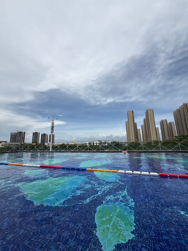 Rooftop pool session above Huizhou's urban skyline