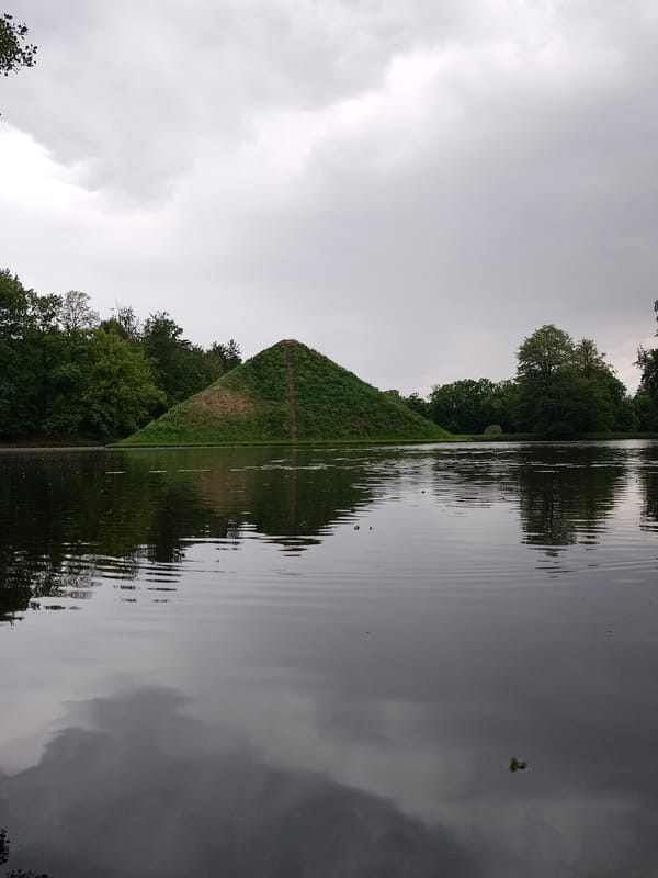 Visitors photograph tiered pyramid hill at Magdeburg's Rotehornpark