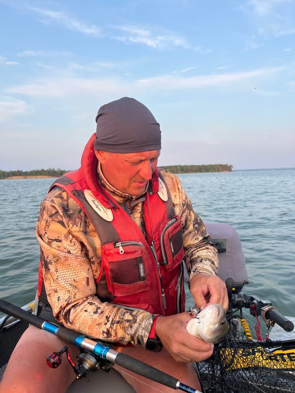 Fishing on the water near Borovoe, fresh catch in hand.