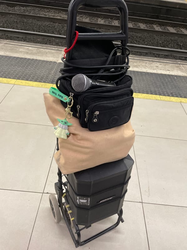 Street performer sets up audio gear on Barcelona subway platform