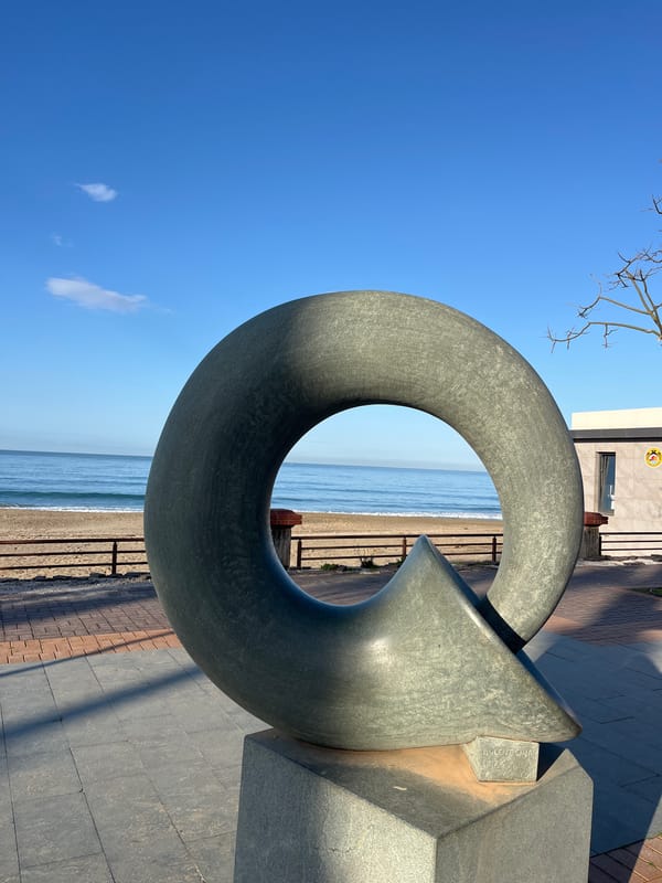 Morning coffee and sculpture captured at Alanya beachfront