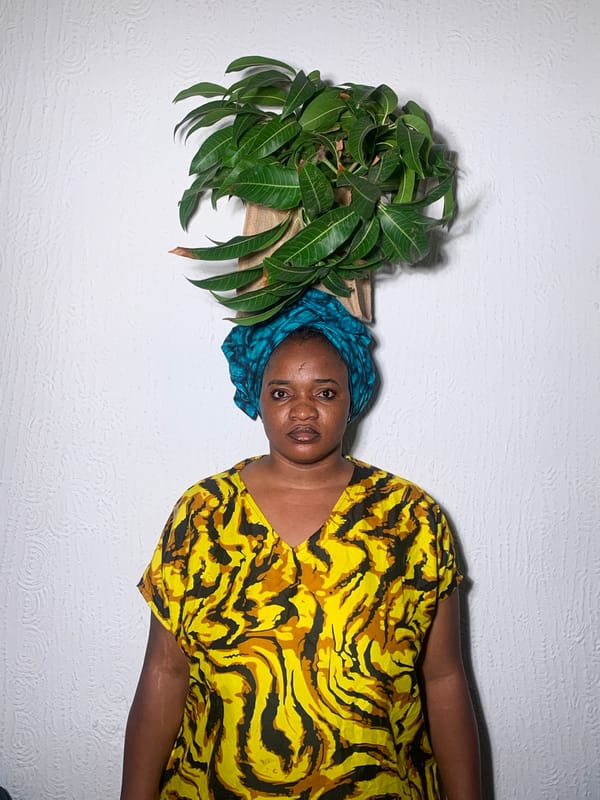 Woman with mango leaves photographed in Nigerian home portrait session