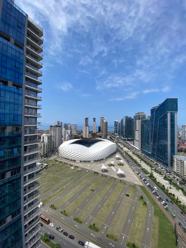 Batumi's coastal skyline mid-construction, stadium and glass towers rising