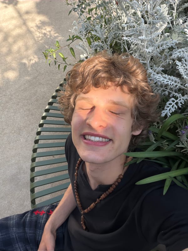 Person photographed smiling outdoors in Milan with mysterious green text