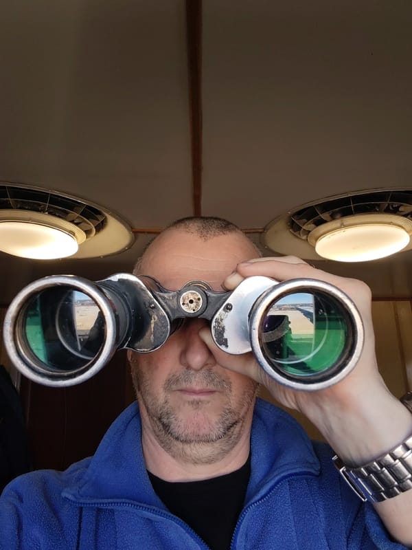 Man with binoculars spotted on deck in Russian village