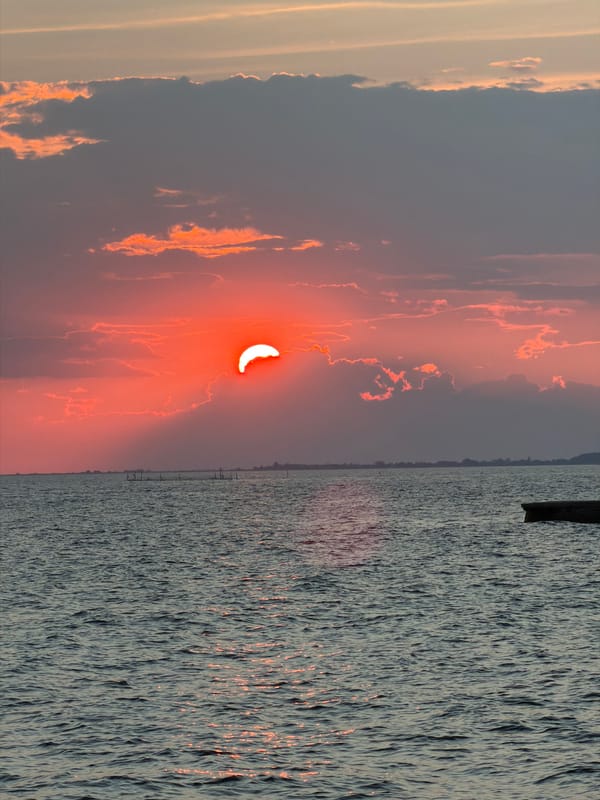 Vivid sunset through cloud cover over the Aegean Sea