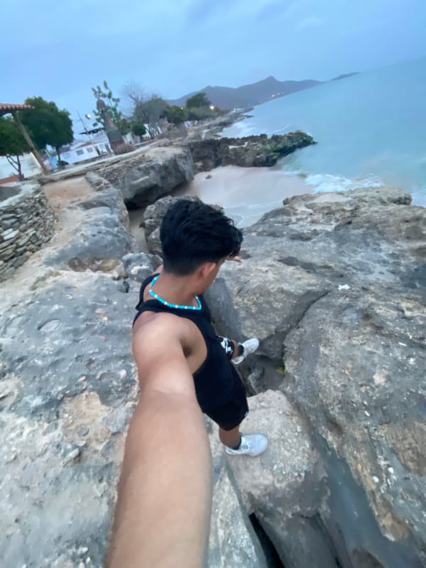 Man visits Juan Griego coastline during cloudy weather