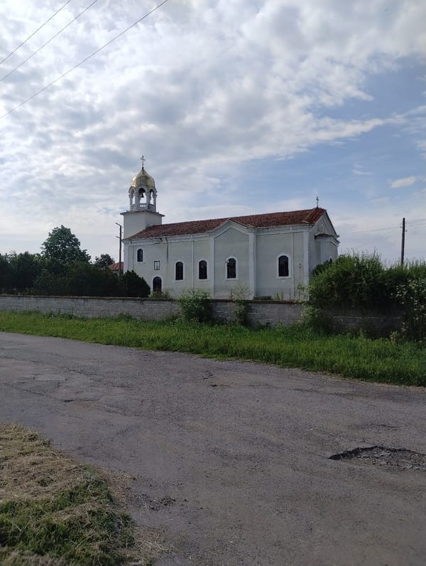 Tourist captures church and roses in Roza, Bulgaria