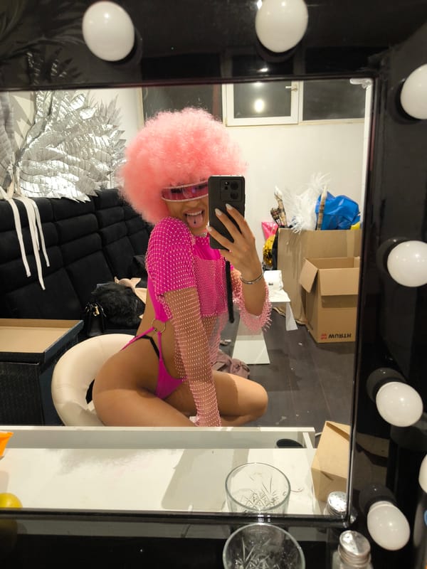 Pink-clad person takes mirror selfies in Sofia dressing room