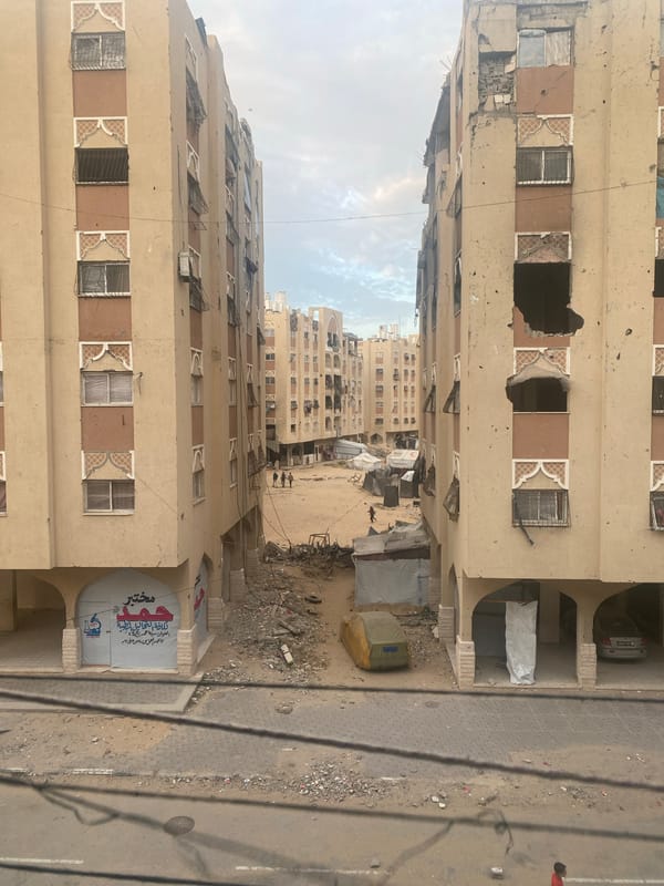 Displacement tents line damaged Khan Yunis street amid debris