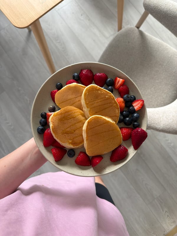 Girl served berry pancakes for breakfast in Latvia