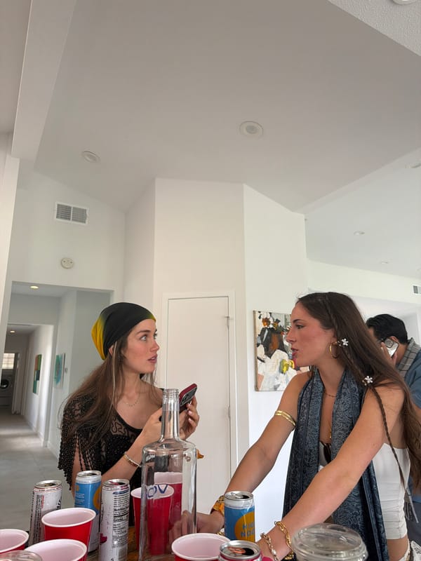 Women pour drinks at indoor gathering in La Quinta