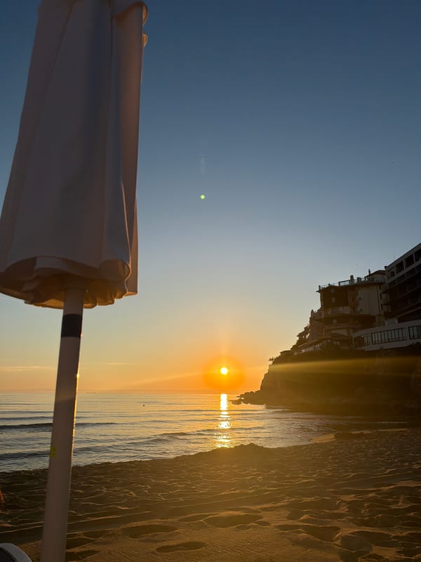 Beach sunrise to sunset: sand, vodka, and a ship sandcastle