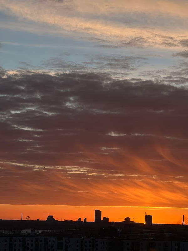 Dramatic sunset displays vibrant colors over Riga, Latvia