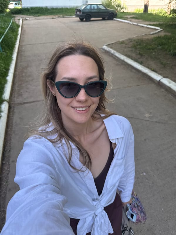 Woman takes selfie on sidewalk in Chaikovsky, Russia