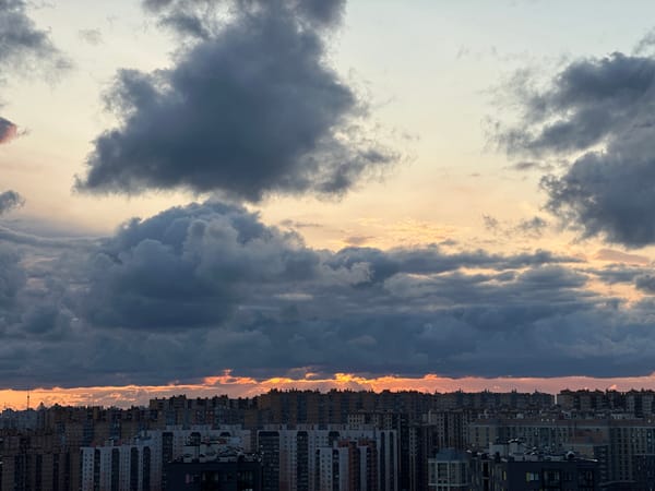 Kudrovo's high-rise skyline under a stormy dusk sky