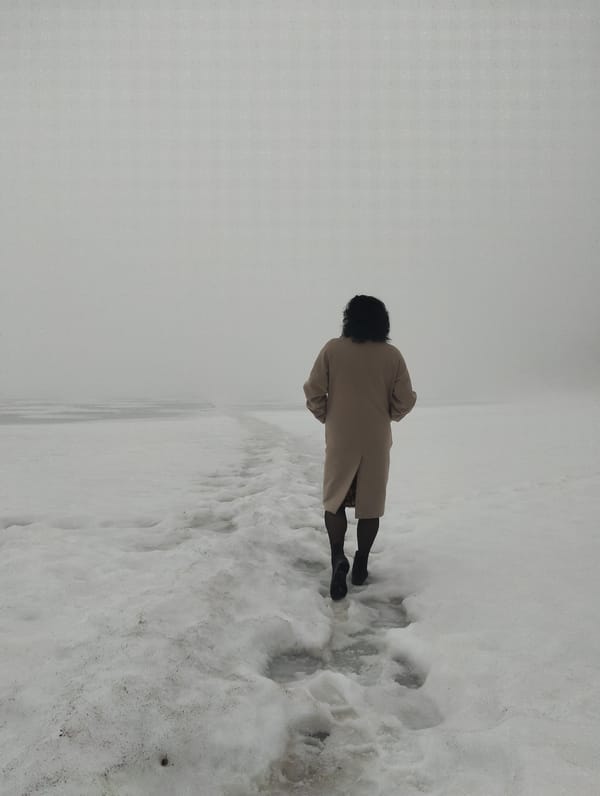 Woman walks through snowy Votkinsk landscape, poses for photos