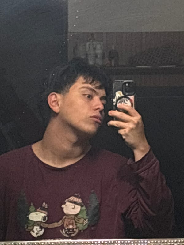 Back-to-back selfies in a dim Mexico City room