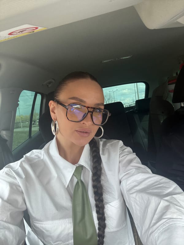 Woman takes car selfie in white shirt, Chaikovsky
